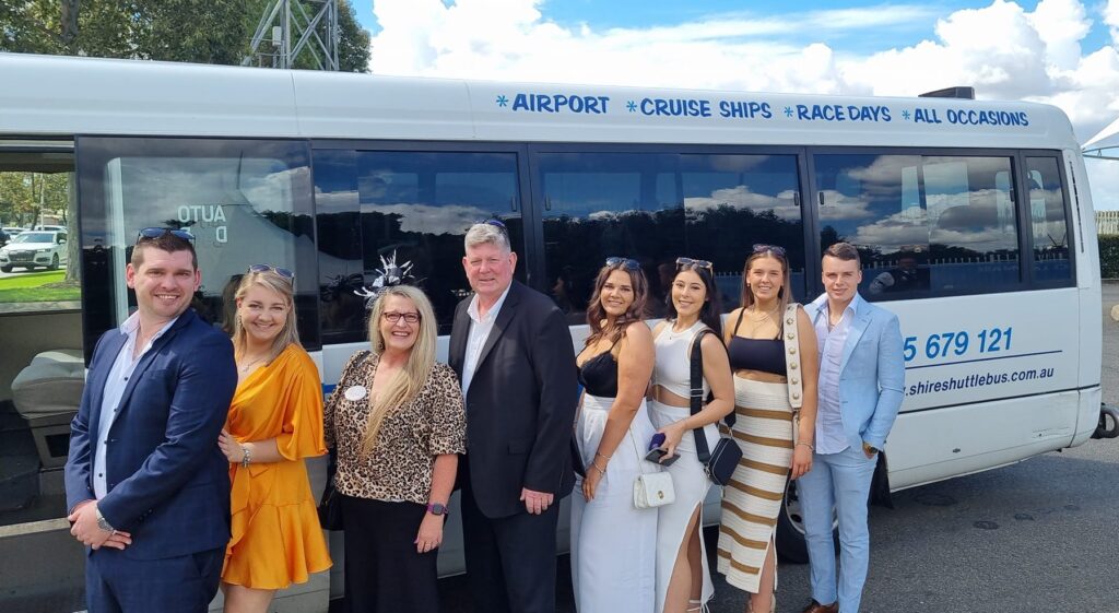 group of people in front of Shire Shuttle Bus ready for Race Day Randwick Races